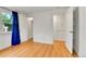 View of a bright bedroom featuring hardwood floors, closet space, and minimalist decor, creating a serene atmosphere at 1930 Hoyt St, Lakewood, CO 80215
