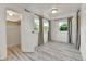 Bedroom with hardwood-look floors, closet, and natural light at 1930 Hoyt St, Lakewood, CO 80215