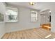Well-lit dining room with wood-look flooring and view of the entryway at 1930 Hoyt St, Lakewood, CO 80215