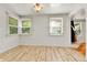 Well-lit dining room with wood-look flooring and large windows at 1930 Hoyt St, Lakewood, CO 80215