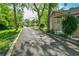 Long driveway leads to home through mature trees at 1930 Hoyt St, Lakewood, CO 80215