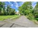 Long paved driveway leading to a single story house with large lawn at 1930 Hoyt St, Lakewood, CO 80215