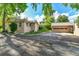 Exterior view of home and garage with driveway at 1930 Hoyt St, Lakewood, CO 80215