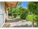 Covered front porch of a single story house surrounded by mature landscaping at 1930 Hoyt St, Lakewood, CO 80215