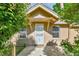 Close up of front porch showing door and house number surrounded by greenery at 1930 Hoyt St, Lakewood, CO 80215