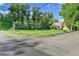View of the house with a large grassy lawn and mature trees at 1930 Hoyt St, Lakewood, CO 80215