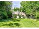 Charming single story home featuring a lush green lawn and mature trees at 1930 Hoyt St, Lakewood, CO 80215