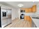 Bright kitchen featuring stainless steel appliances and wood-look flooring at 1930 Hoyt St, Lakewood, CO 80215