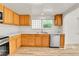Bright kitchen featuring stainless steel appliances, white countertops, and wooden cabinets at 1930 Hoyt St, Lakewood, CO 80215