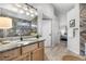 Elegant bathroom featuring granite countertop, wood cabinets, and an open view to another part of the home at 6001 S Yosemite St # H204, Greenwood Village, CO 80111
