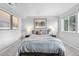 Calm bedroom featuring neutral decor, mountain art, and comfortable furnishings and natural light from a window at 6001 S Yosemite St # H204, Greenwood Village, CO 80111