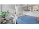 Bright bedroom with soft blue bedding, neutral walls, and a green plant adding a touch of nature at 6001 S Yosemite St # H204, Greenwood Village, CO 80111