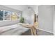 Serene bedroom with a large window offering natural light and view of outdoor foliage and neutral bedding at 6001 S Yosemite St # H204, Greenwood Village, CO 80111