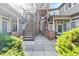 Open-air courtyard with stair access to units, brick accents, and well-manicured shrubs at 6001 S Yosemite St # H204, Greenwood Village, CO 80111