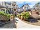 Inviting condo exterior with a well-maintained landscape and exterior staircase access to the units at 6001 S Yosemite St # H204, Greenwood Village, CO 80111