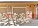 Attached single car garage with tan door, red brick base, and light fixture at 6001 S Yosemite St # H204, Greenwood Village, CO 80111