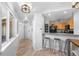 Hallway next to the kitchenette features wood floors and access to the front door and windows at 6001 S Yosemite St # H204, Greenwood Village, CO 80111