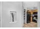 Bright kitchen area with black appliances, wood cabinets, and recessed display shelf in the hallway at 6001 S Yosemite St # H204, Greenwood Village, CO 80111