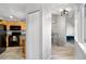 Open kitchen and bar area with wood cabinets, modern lighting, and seating in a bright space at 6001 S Yosemite St # H204, Greenwood Village, CO 80111