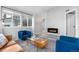 Living room with vaulted ceilings, modern furniture, a black fireplace, and bright windows at 6001 S Yosemite St # H204, Greenwood Village, CO 80111