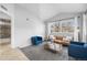 Open concept living room has modern furniture, bright windows, and access to bathroom at 6001 S Yosemite St # H204, Greenwood Village, CO 80111