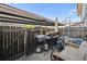 Enclosed backyard with a metal patio cover, multiple grills, and privacy fence at 2567 Rainbow Dr # 80, Denver, CO 80229