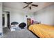 Well-lit bedroom offering cozy carpet and a metal bed frame at 2567 Rainbow Dr # 80, Denver, CO 80229