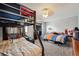 Shared bedroom featuring a bunk bed, full bed, and neutral color scheme at 2567 Rainbow Dr # 80, Denver, CO 80229