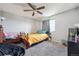 Comfortable bedroom featuring plush carpeting, a ceiling fan, and a sunny window with gray curtains at 2567 Rainbow Dr # 80, Denver, CO 80229