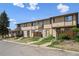Exterior view of the townhome complex, showing units, landscaping, and street access at 2567 Rainbow Dr # 80, Denver, CO 80229