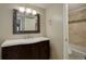 The bathroom is stylishly appointed with a modern vanity and tiled shower and backsplash at 6490 S Dayton St # L10, Englewood, CO 80111