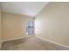 Cozy carpeted bedroom featuring a bright window with natural light and neutral wall colors at 6490 S Dayton St # L10, Englewood, CO 80111