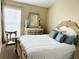 Cozy bedroom with an ornate bed frame, matching mirror dresser, and soft light creating a relaxing atmosphere at 6490 S Dayton St # L10, Englewood, CO 80111