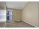 Bedroom features neutral carpet, paint, and a window with blinds at 6490 S Dayton St # L10, Englewood, CO 80111