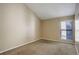 Cozy carpeted bedroom featuring a bright window with natural light and neutral wall colors at 6490 S Dayton St # L10, Englewood, CO 80111
