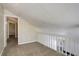 View of hallway from loft showing neutral carpet and paint throughout at 6490 S Dayton St # L10, Englewood, CO 80111