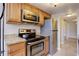 The kitchen features stainless steel appliances, granite countertops and wood cabinets at 6490 S Dayton St # L10, Englewood, CO 80111