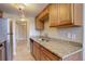 Galley-style kitchen boasts stainless steel appliances, granite countertops and wood cabinets at 6490 S Dayton St # L10, Englewood, CO 80111