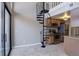 A living room with a spiral staircase, kitchen and sliding glass doors at 6490 S Dayton St # L10, Englewood, CO 80111