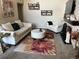 Elegant living room with plush seating, decorative rug, fireplace, and bright natural light at 6490 S Dayton St # L10, Englewood, CO 80111