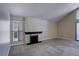 View of living room highlighting a fireplace and large windows with blinds at 6490 S Dayton St # L10, Englewood, CO 80111