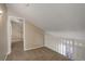 Loft area featuring neutral walls, plush carpeting, and a white railing overlooking the downstairs at 6490 S Dayton St # L10, Englewood, CO 80111
