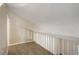 Loft area featuring neutral walls, plush carpeting, and a white railing overlooking the downstairs at 6490 S Dayton St # L10, Englewood, CO 80111