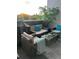 Relaxing outdoor patio with comfortable wicker furniture and natural accents at 6490 S Dayton St # L10, Englewood, CO 80111