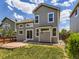 A home's backyard has green grass, a stone patio, a wood fence, and trees around the perimeter at 4287 Brookwood Pl, Highlands Ranch, CO 80130