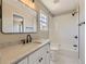 Well-lit bathroom featuring a white vanity, a bathtub, a shower, and modern fixtures, offering a clean and functional space at 4287 Brookwood Pl, Highlands Ranch, CO 80130