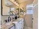 Elegant bathroom with double sinks, marble countertops, modern fixtures, and ample lighting, creating a spa-like experience at 4287 Brookwood Pl, Highlands Ranch, CO 80130