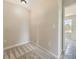 A small bedroom with neutral walls, carpet, base trim, and electrical outlets on the walls at 4287 Brookwood Pl, Highlands Ranch, CO 80130