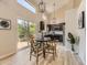 Eat in kitchen with stainless appliances, modern chandelier, and large sliding glass doors at 4287 Brookwood Pl, Highlands Ranch, CO 80130