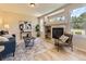 Cozy living room featuring a fireplace, comfortable seating, natural light, and stylish décor, creating a warm and inviting atmosphere at 4287 Brookwood Pl, Highlands Ranch, CO 80130
